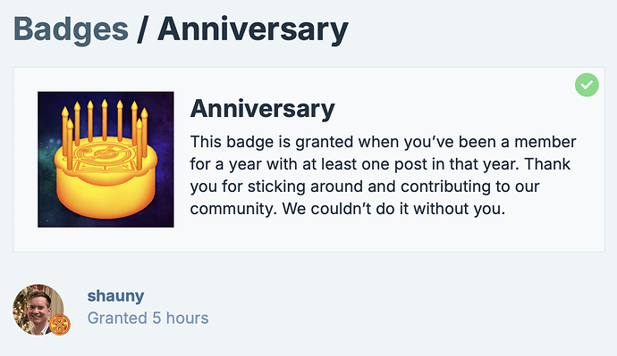 This image shows an "Anniversary" badge granted for being a community member for a year with at least one post, accompanied by a small profile picture labelled "shauny", granted 5 hours ago.